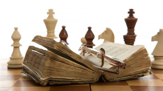 Chess Set With A Book On It