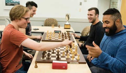 Two teams of two players each face off over two separate chess boards - Bughouse Chess