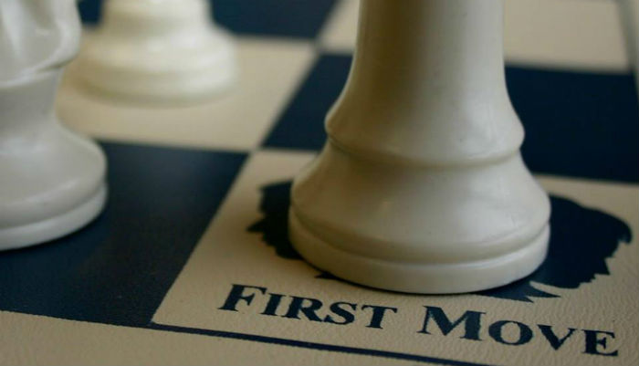 First Move Logo on a Chessboard